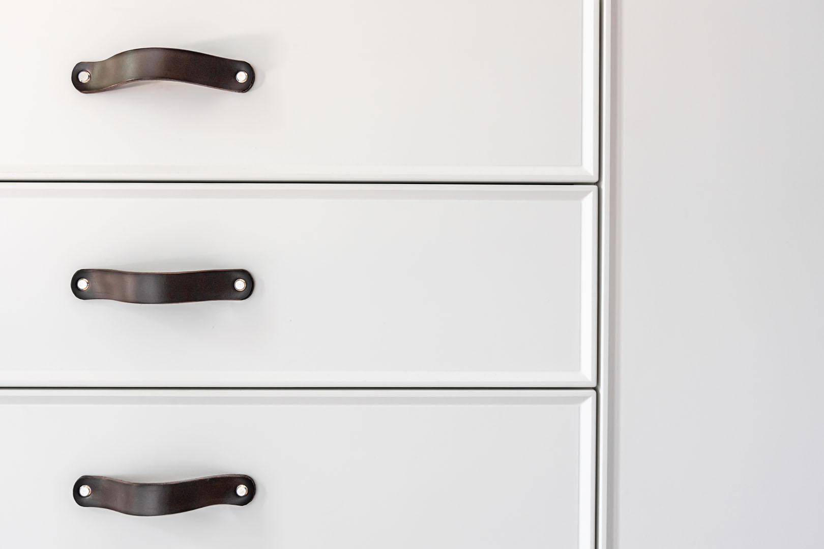 Black handles of the kitchen drawer or cabinet.