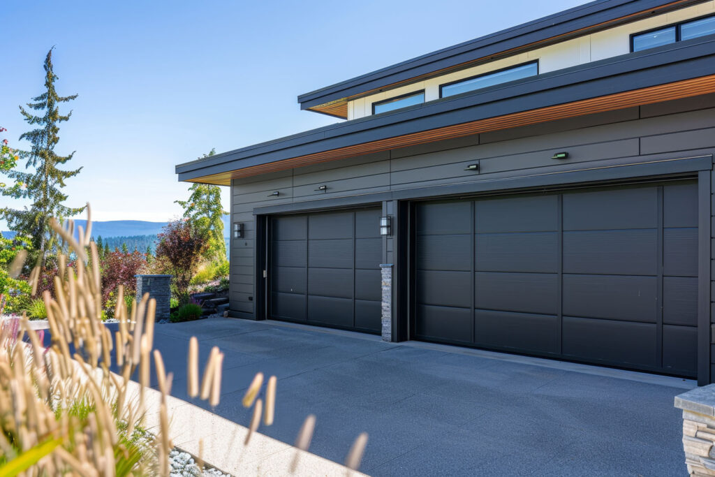 A black garage door with a white trim sits in front of a house