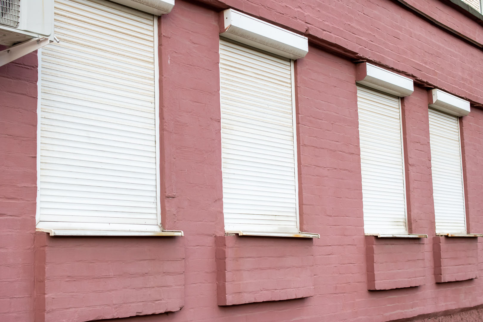 Blinds on windows of red brick building